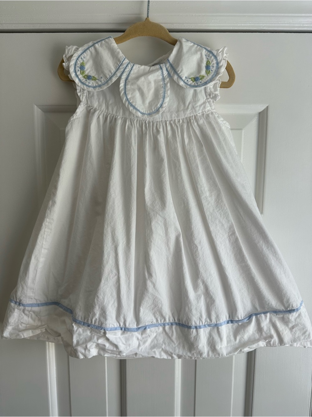 White Cotton Girls' Dress with Blue Trim and Embroidered Collar